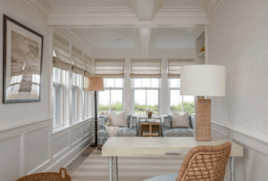 Bright, airy interior design featuring a modern workspace and cozy seating area, showcasing personalized decor and natural light, relevant to Coastal Cottage of Amelia's interior design services.