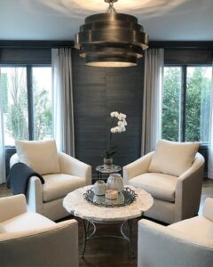 A cozy living room featuring two chairs and a coffee table, creating a welcoming seating area.