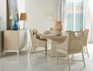 A spacious dining room featuring a large wooden table surrounded by several elegant chairs.